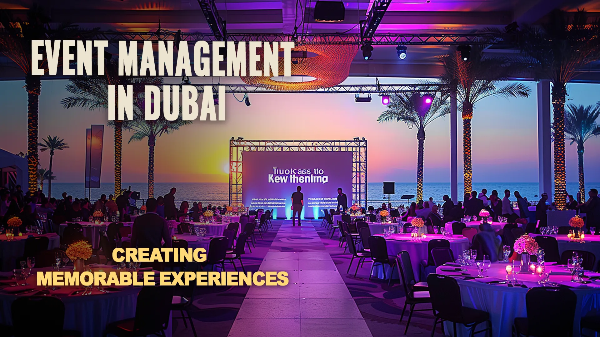 Event in a large restaurant in Dubai, with tables lining the sides where guests sit, and a screen in the center of the hall, with the sea and palm trees visible in the background