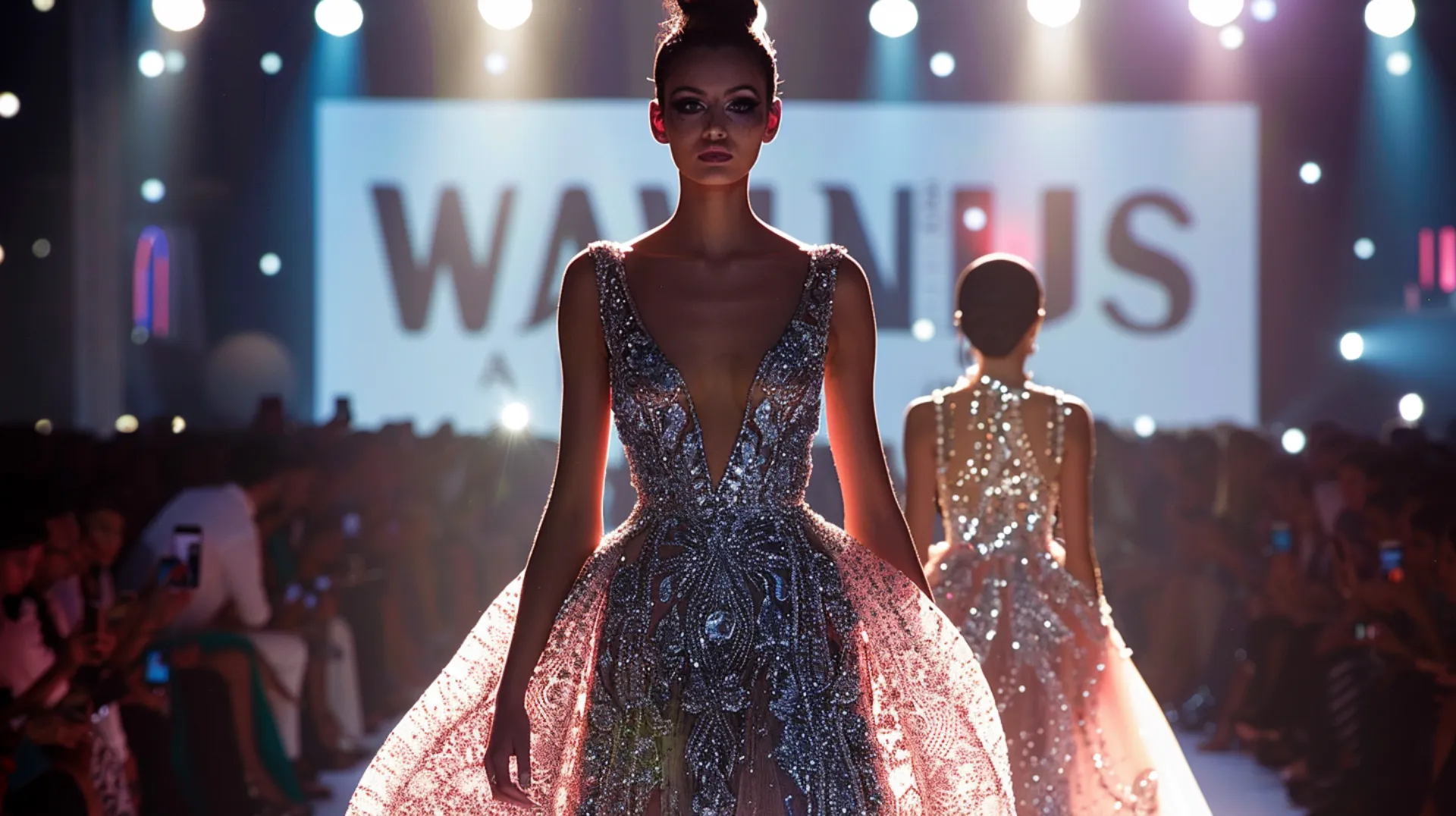  A model in an evening gown walks the Dubai fashion show runway, with another model visible in the background